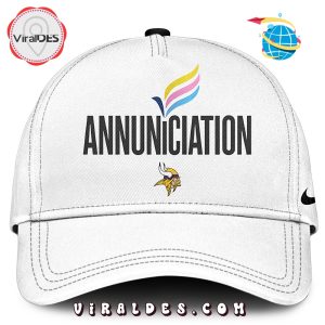 White Annunciation cap with colorful emblem and Vikings logo.