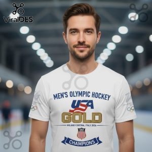White t-shirt with 'Men's Olympic Hockey USA GOLD Milano Cortina, Italy 2026 Champions' design.!