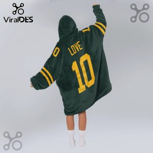 Person wears a green hooded blanket with yellow stripes/number 10/LOVE printed on the back.!