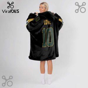 Black oversized hoodie blanket with LOVE and number 10 in green and gold on the back, worn by a blonde woman!