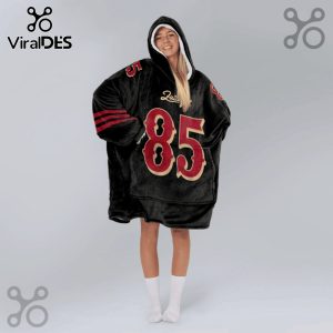 Woman wearing a black oversized hoodie with red stripes on the sleeves and the number 85 on the front and 5 on the shoulders.!