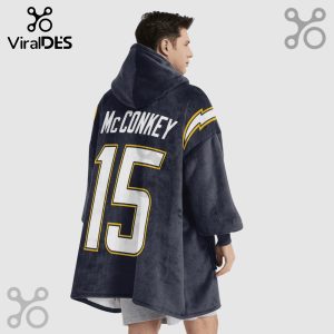 Person wearing a hooded blanket with 'McCONKEY' and the number '15' printed on the back, Chargers colors and lightning bolt.!
