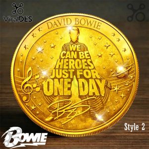 Gold coin featuring David Bowie silhouette made of 'WE CAN BE HEROES JUST FOR ONE DAY' text, stars, music notes, planet, and signature!