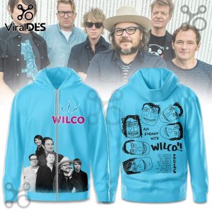 Light blue hoodie, front has Wilco logo with lightning bolt, band photo. Back features six cartoon faces, 'An Evening With Wilco!!' 2026 tour dates!