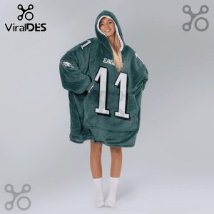 Person wearing an oversized hooded blanket with an Eagles jersey design, featuring the number 11.!