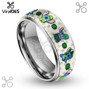 Close-up of a silver ring featuring Stitch wearing a St. Patrick's Day hat and shamrocks on a light background.!