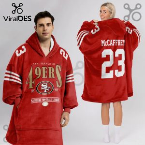 Red oversized hoodie featuring 49ers logo, McCaffrey and number 23. Sports design.!