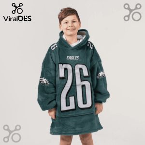Child wears a green Eagles #26 oversized hoodie blanket.!