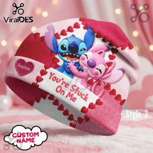 Stitch and Angel hug on a pink and red beanie! 'You're Stuck On Me' text! A heart displays 'Sophie' for custom personalization!