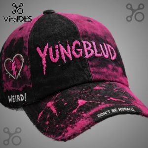YUNGBLUD cap with pink splatter, embroidered text, broken heart graphic, and 