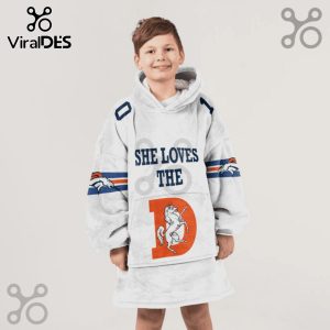 Child wears a hooded blanket with 'SHE LOVES THE' text, a horse inside of a D and the Denver Broncos logo.!