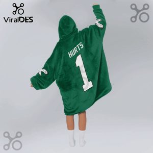 Person wearing a green oversized hoodie with 'Hurts' and the number '1' on the back.!