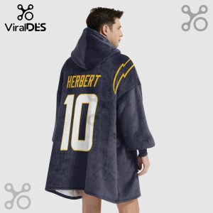 Person wearing a hooded blanket with 'HERBERT' and the number '10' on the back, with lightning bolt design.!
