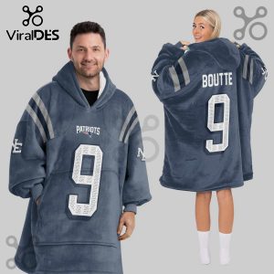 Two adults wearing oversized hoodie blankets with football jersey design; one says 'Patriots 9,' the other 'Boutte 9'.!