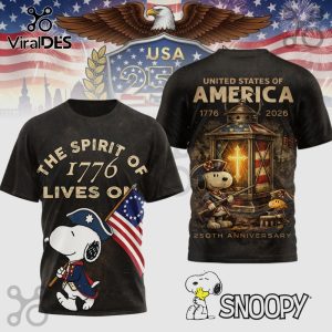 Distressed black tee featuring Snoopy in patriot gear, 'The Spirit of 1776 Lives On'! 250th anniversary design!