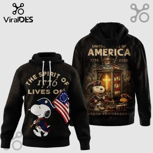 Black hoodie featuring Snoopy and Woodstock, American flag, and text: 'The Spirit of 1776 Lives On,' 'America 1776-2026'.!