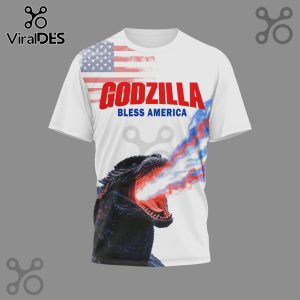 White t-shirt featuring Godzilla graphic, the American flag, and the text 'Godzilla Bless America'.!
