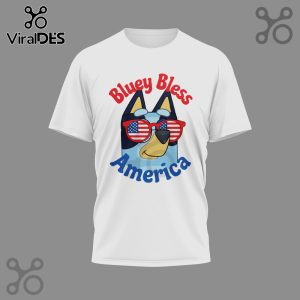 White t-shirt with Bluey wearing sunglasses with the American flag and 'Bluey Bless America' text.!