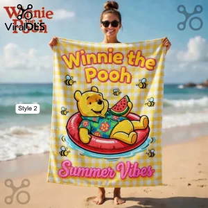 A yellow gingham beach towel with Winnie the Pooh in an inner tube and text 'Winnie the Pooh Summer Vibes'!
