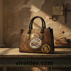 Brown handbag with gold, silver rings, Elvish script, SD Padres logo, and 'PADRES' text! Fantasy sports crossover style!