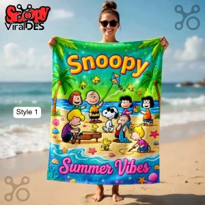 A colorful beach towel with Snoopy and Peanuts characters! Features the text 'Snoopy' and 'Summer Vibes' in a bright design!