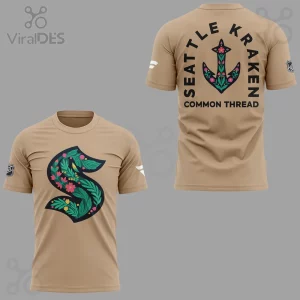 Tan Seattle Kraken botanical tee! Front floral S logo green pink yellow, back floral anchor with 'SEATTLE KRAKEN COMMON THREAD' text!