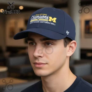 Navy blue collegiate baseball cap with yellow M logo and white text: 2026 NATIONAL Champions NCAA DIVISION I MEN'S BASKETBALL!