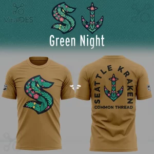 Khaki t-shirt with floral Seattle Kraken 'S' logo in green, pink, yellow! Back features floral anchor and 'SEATTLE KRAKEN COMMON THREAD' text!