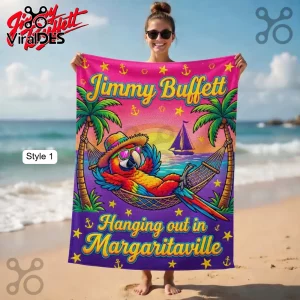 Vibrant beach towel with cartoon parrot in hammock! Text says 'Jimmy Buffett Hanging out in Margaritaville'! Pink and purple!