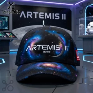 Black baseball cap with blue and purple galaxy print and white text reading 'ARTEMIS II 2026' with a moon graphic and USA flag!