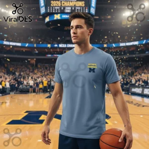 Light blue grey tee with NATIONAL CHAMPIONS yellow text and a dark blue M logo! Sports fan shirt for basketball enthusiasts!