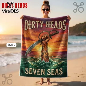 Dirty Heads Seven Seas blanket with a vintage pirate design of a tattooed arm holding a cutlass against a sunset background!