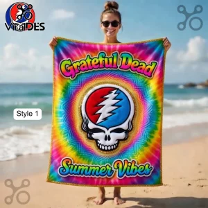 A psychedelic rainbow tie-dye towel with the Grateful Dead Steal Your Face skull logo and text 'Grateful Dead Summer Vibes'!