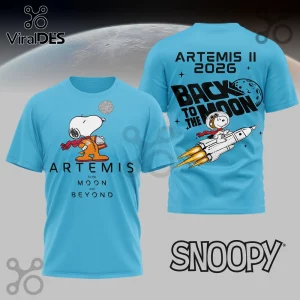 Light blue t-shirt with Snoopy astronaut design! Text reads Artemis To the Moon and Beyond and Back to the Moon Artemis II 2026!