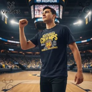Dark blue, yellow, orange collegiate sports championship tee, 'NCAA Men's Basketball National Champs 2026 M Michigan Wolverines Final Four Minneapolis'!