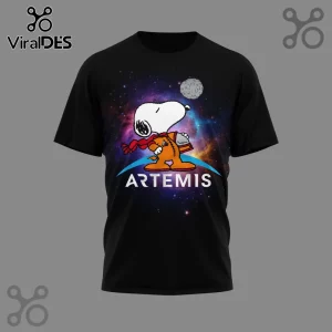 Black tee with cartoon Snoopy astronaut in orange suit looking at the moon against a galaxy background and white 'ARTEMIS' text!