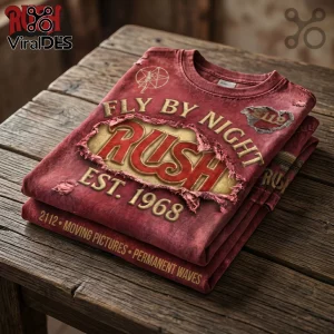 Red vintage style Rush band t-shirt with Fly By Night and 2112 text on a wooden table!