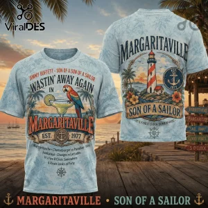 Light blue tropical t-shirt featuring Jimmy Buffett Margaritaville lighthouse parrot and drink graphics in vintage style!