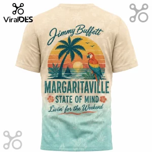 Vintage Jimmy Buffett Margaritaville tee featuring a sunset, palm tree, parrot, and text on a tropical gradient background!