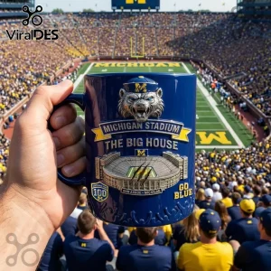 Blue ceramic mug with raised metallic Michigan Stadium Big House graphics and Wolverine mascot logo for University fans!
