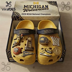 Yellow Crocs featuring Michigan Wolverines 2026 NCAA champion charms including mascot, basketball, ring, and trophy.!