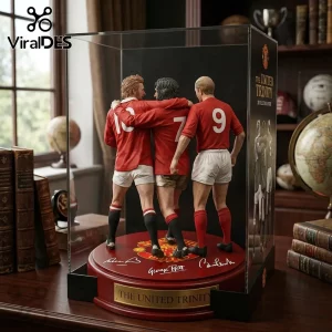 Red retro Manchester United football trinity figurine with numbers 10, 7, 9, on a base reading 'THE UNITED TRINITY' with signatures of Law, Best, Charlton!