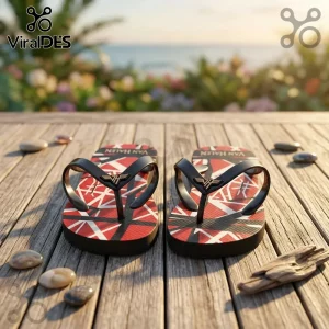 Flip-flops with iconic red white and black striped pattern and VH logo on black straps against a wooden beach backdrop!