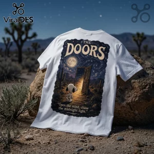 White t-shirt featuring a Snoopy character standing before a door in a desert under a starry sky with The Doors text.!