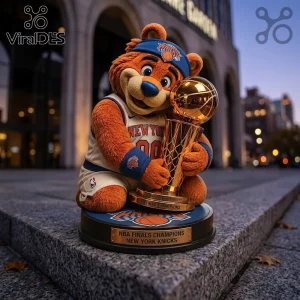 New York Knicks mascot plush figure holding a gold Larry O'Brien trophy on a circular base with championship text.!