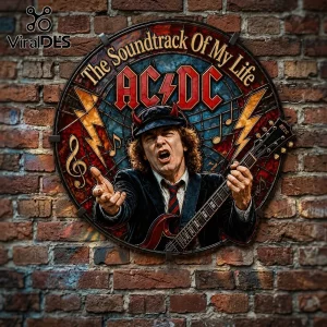 Round AC/DC wall sign featuring Angus Young with devil horns, text reads The Soundtrack Of My Life on a brick wall.!