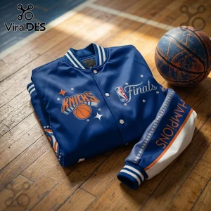New York Knicks royal blue satin varsity jacket with NBA Finals rhinestone logo and Champions text on hardwood floor.!