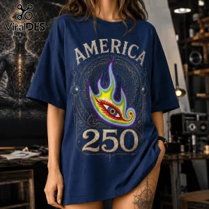 Navy blue t-shirt with America 250 text, a central rainbow flame-shaped eye graphic, and intricate gold geometric borders.!