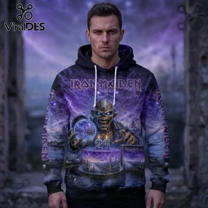Man wearing a purple Iron Maiden hoodie featuring Eddie, a number 26 birthday cake, and album art on a stormy background.!