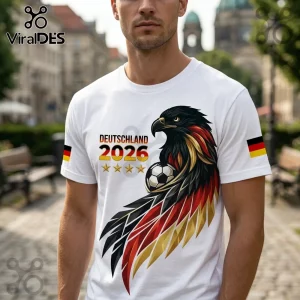 White t-shirt featuring a German eagle graphic with black, red, and gold feathers, a soccer ball, and Deutschland 2026 text.!